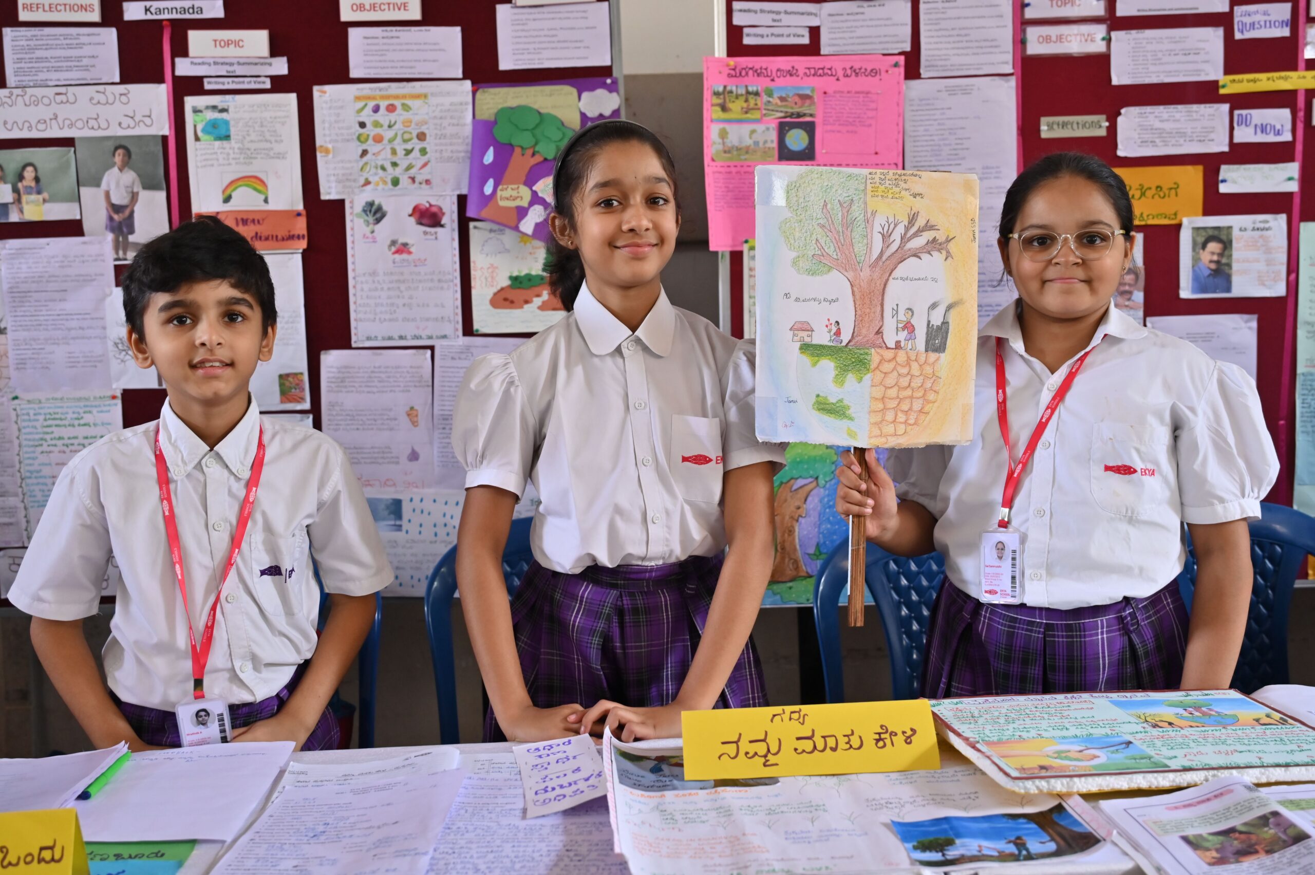 Students at EKYA international school in Bangalore showcasing their Kannada language projects, displaying bilingual learning approach with classroom displays and creative work in both English and Kannada