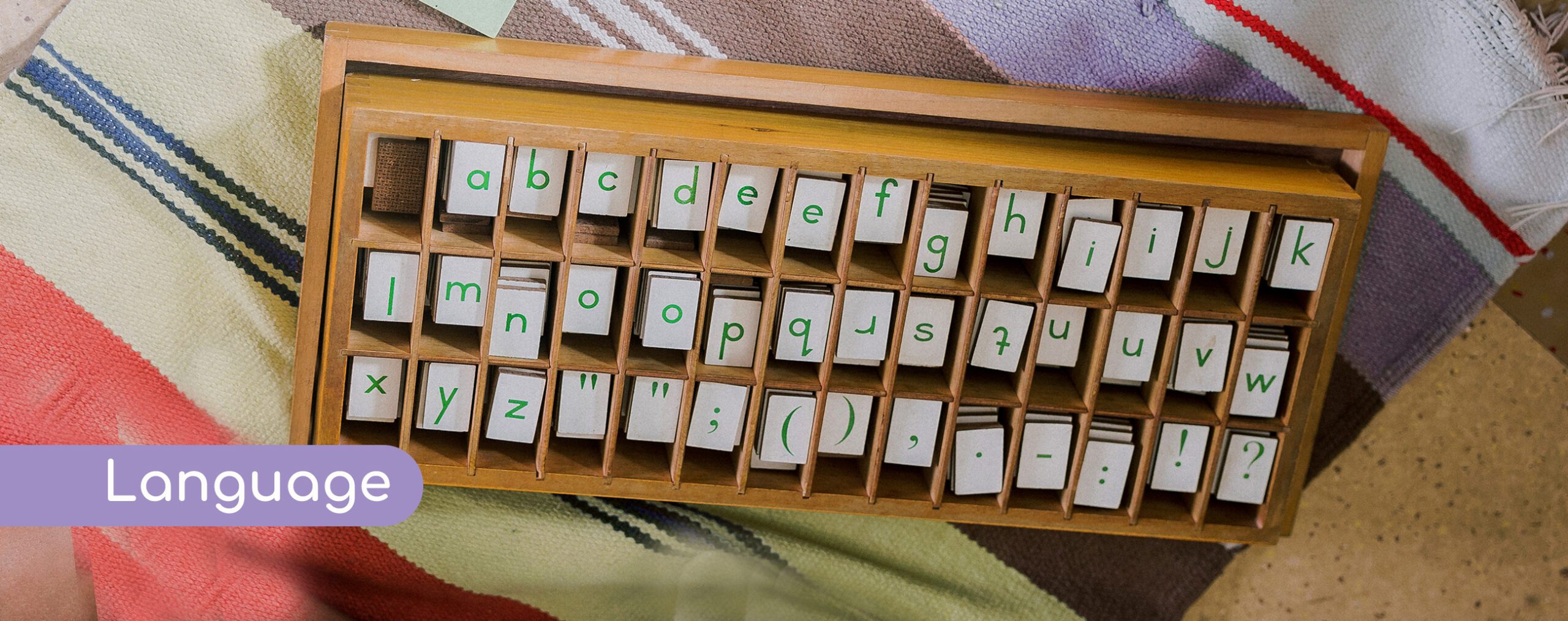 Wooden alphabet organizer showing language learning materials at EKYA NAVA international school in Panathur, demonstrating structured literacy programs for IGCSE curriculum